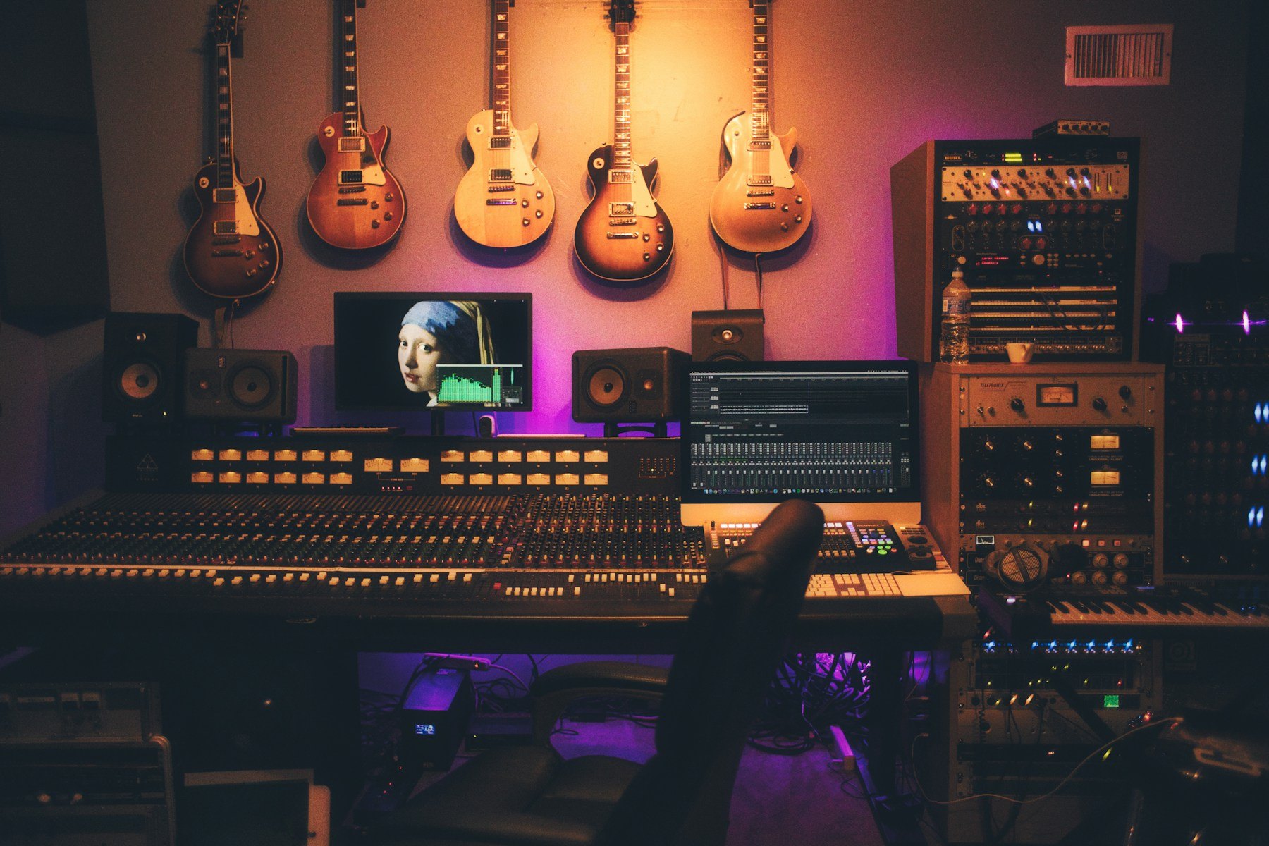 Illustrative recording studio interior with mixing console and guitars